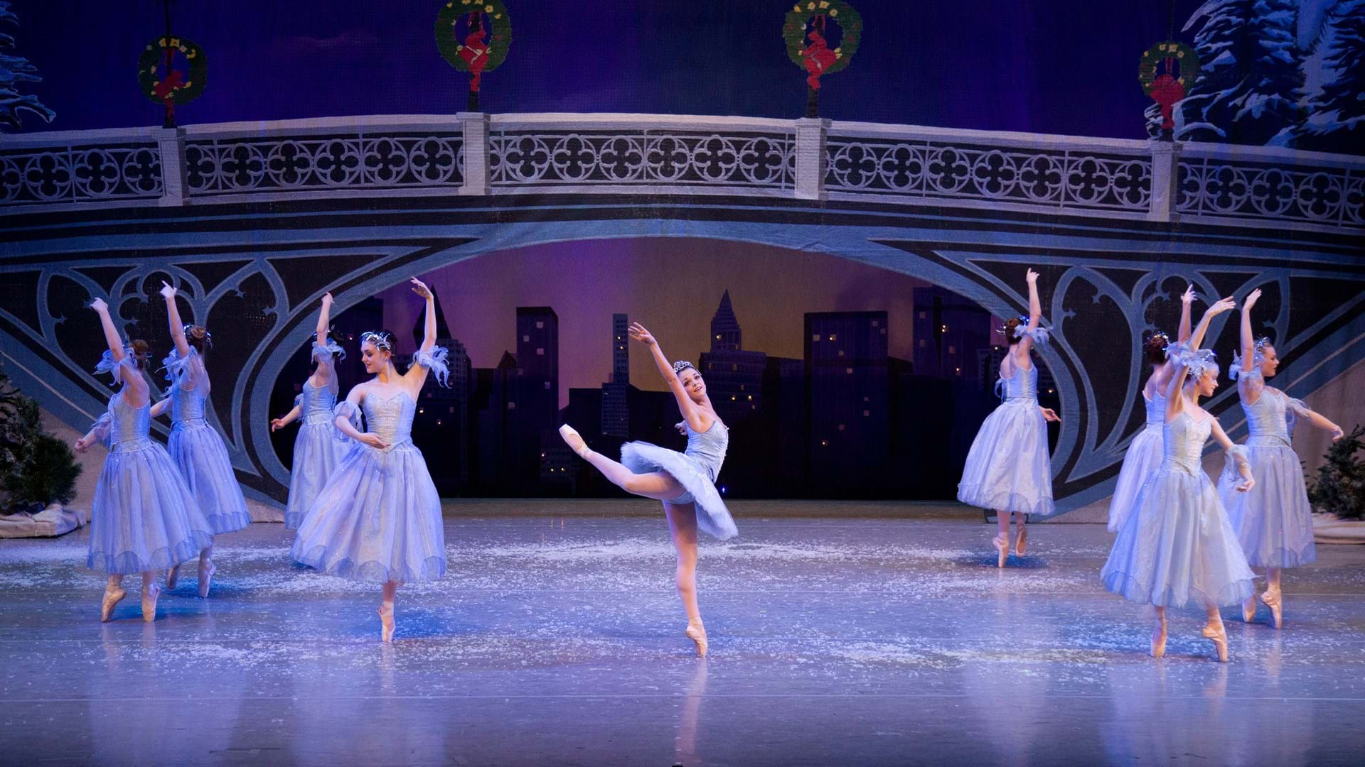 A ballet dancer dressed in blue poses dancing with hand and leg raised. Text reads A Buck A Kid