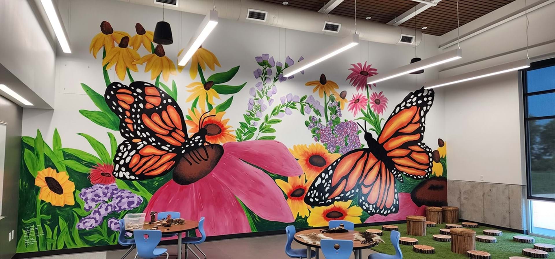 This mural, featuring indigenous Iowan prairie flowers and monarch butterflies, was painted by Fort Dodge Senior High and Iowa Central Community College students.