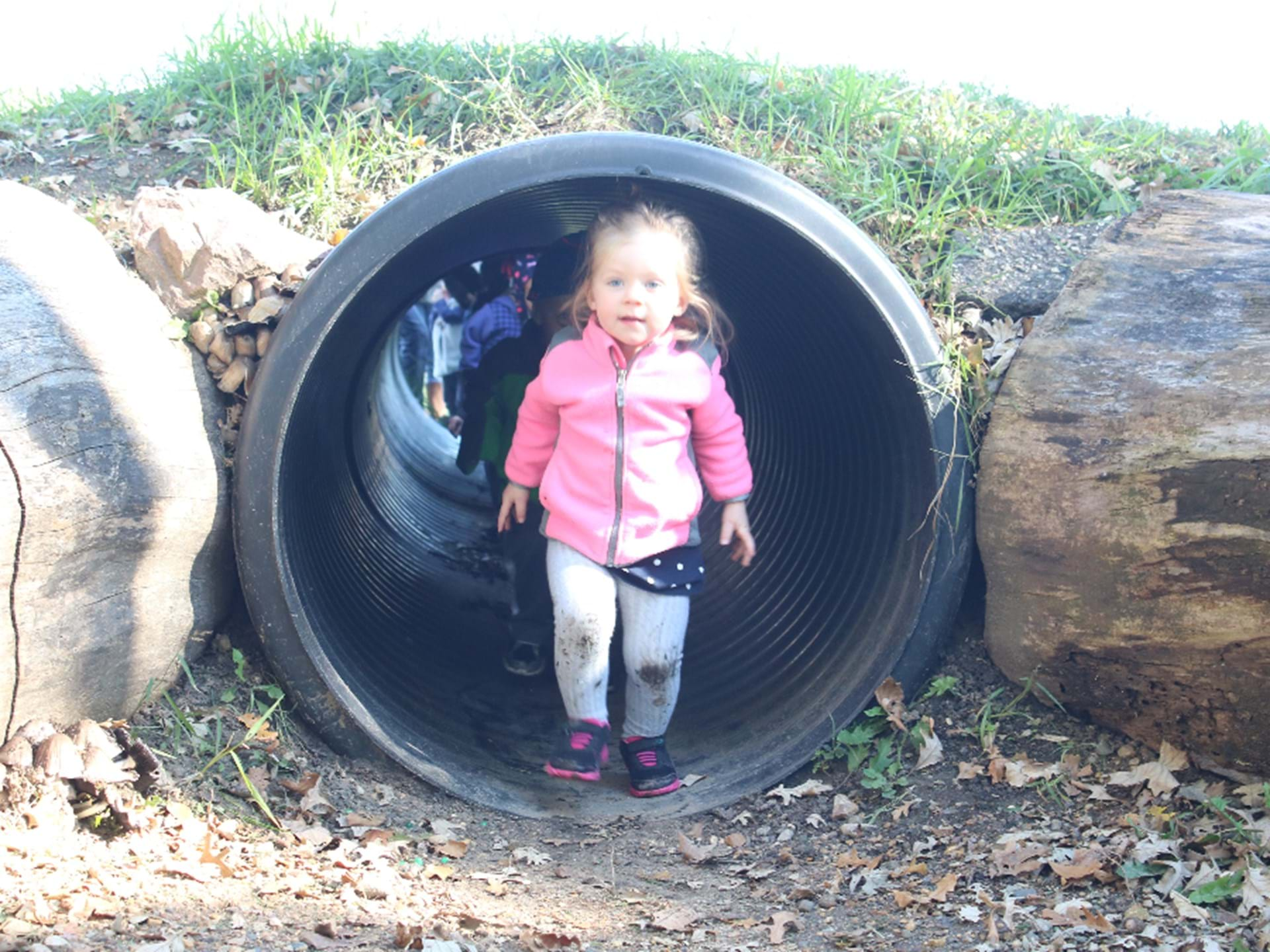 Play in the underground tunnel in the Nature Playscape